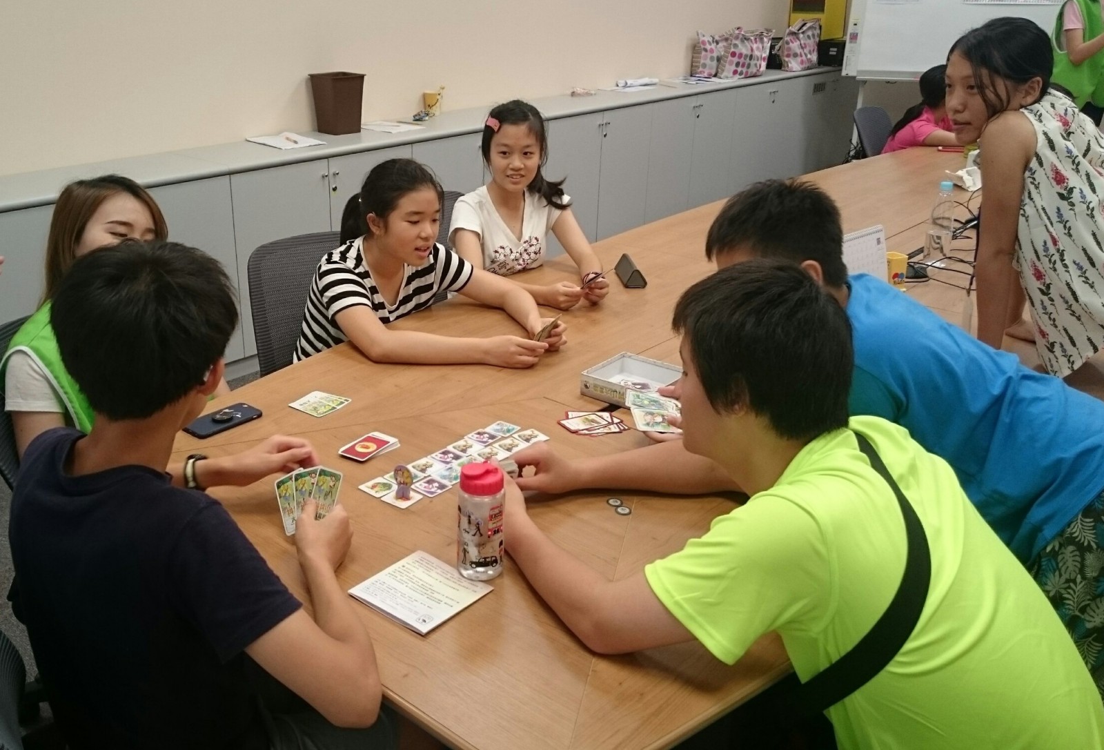 Teenagers played board game <Mystic Mountains Adventures>, while applying communication skills they just learned.